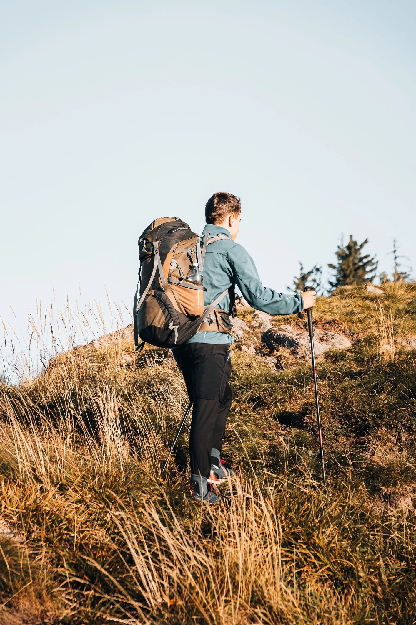 Backpacker standing on a mountain summit